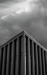 Vertical shot of the Torre Picasso under the clouds in Madrid, Spain in grayscale