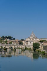 Fototapeta premium Beautiful view of a bridge over the Tiber river and St. Peter's Basilica in Rome, Italy