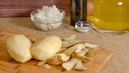 Peeling and cutting potatoes. Vegetables soup recipe. Fresh raw vegetables close-up