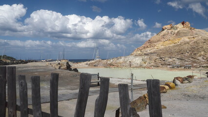  A hotspring, rocky hill and harbor at Lipari Island Sicily Italy