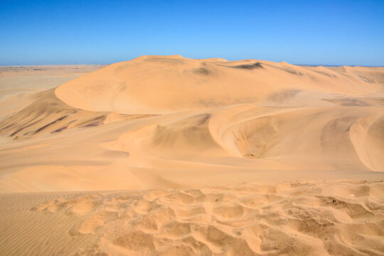 Desert dry landscape with sand dunes under blue sky. Global warming and climate change