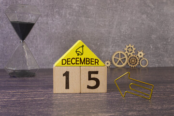 Wooden calendar of December 15 date standing in the snow in nature