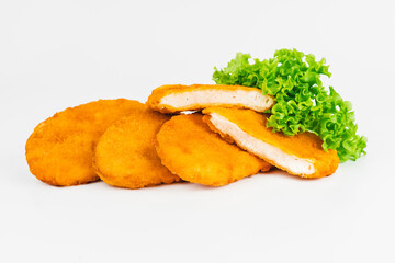 Breaded chicken nuggets.Breaded Chicken Inner Fillet with green lettuce leaves on a White Background.Chicken Breaded Raw Meat,Fillet.Fast homemade food at home. Chicken breaded schnitzels.Fast cooking