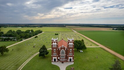 Aerial view of Salemsborg Lutheran Church in a green field near a cemetery in Saline County, Kansas