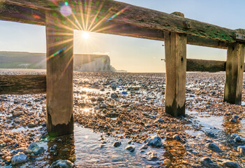 Seven Sisters white cliffs seen from the beach at sunrise. East Sussex. England - obrazy, fototapety, plakaty