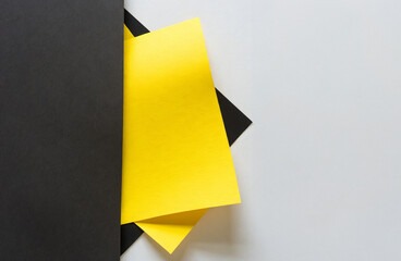 Stacked yellow and black smooth paper forms an unusual background.