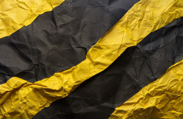 Stacked yellow and black wrinkled or crumpled paper forms an unusual background.