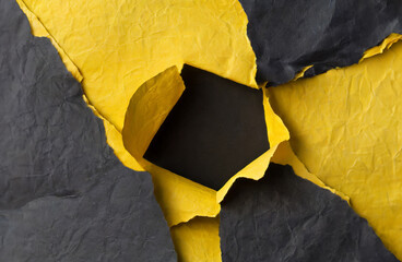 Stacked yellow and black wrinkled or crumpled paper with a hole in the middle forms an unusual background.