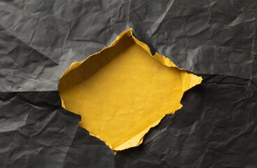 Stacked yellow and black wrinkled or crumpled paper with a hole in the middle forms an unusual background.
