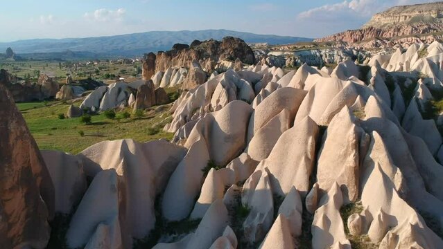 Drone view of rocky formations in Cappadocia during the golden hour in Turkey