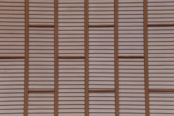 old wooden wall in the shape of small squares arranged together.