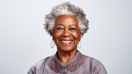 This close-up studio photo features a senior African American woman with grey hair, isolated on a white background, highlighting her elegance and character.