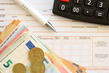 Filling italian tax form process with pen, calculator and euro money bills close up. Tax paying...