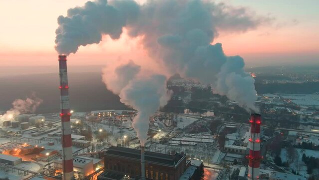 Aerial view of heating plant and thermal power station. Combined modern power station for city district heating and generating electrical power. Industrial zone from above.