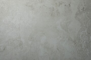 Texture of light grey stone surface as background, closeup