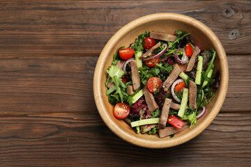 Delicious salad with beef tongue and vegetables on wooden table, top view. Space for text