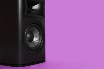 One wooden sound speaker on violet background, closeup. Space for text