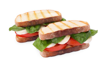 Delicious Caprese sandwiches with mozzarella, tomatoes and basil isolated on white