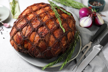 Delicious baked ham served on light grey table, closeup