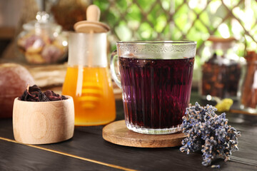 Aromatic herbal tea, dry lavender and honey on wooden table, closeup