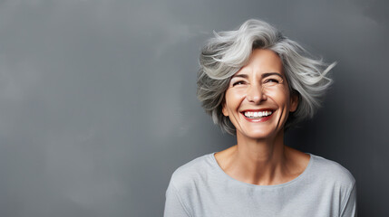 happy  silver hair white 50's woman grey background  - obrazy, fototapety, plakaty
