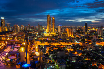 Fototapeta na wymiar Top view point from roof top bar, highest Building in bangkok city with blue sky in silom district are