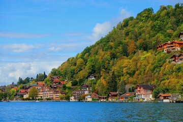 Swiss houses and buildings surround elevated hill on blue sky background 2
