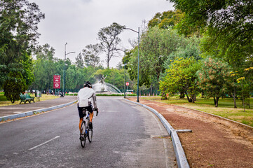 person riding a bike in chapultepec park in mexico city 
