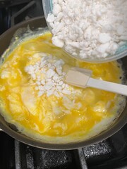 Making scrambled eggs with feta cheese