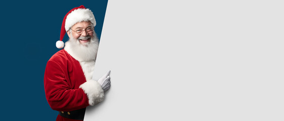 Happy Santa Claus with holding a big white sign on a blue background copy space - mockup