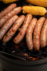 vertical Extreme Close-Up of Peruvian Barrel Grill with Chorizos and Roasted Corn