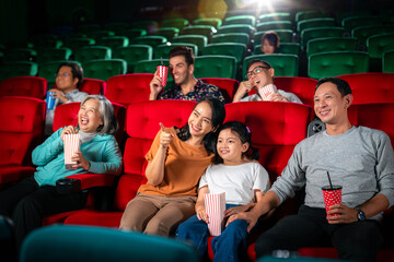 Happy group of asian family and grandmother relax and go to Cimema in movie theater