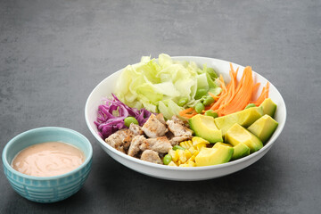 Healthy Salad Bowl, mix vegetables carrots, lettuce, cabbage, potatoes, chicken and avocado
