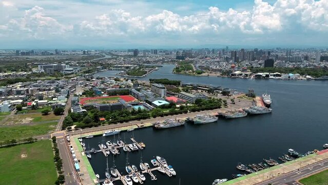 Aerial 4k footage of Tainan city with river crossing in the middle and boats in Taiwan.