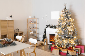 Interior of living room with dining table, Christmas tree and fireplace