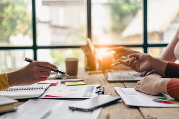 Happy young Asian businessmen and women work together in the office. Brainstorming meeting of creative teams, internet technology, financial business partners Close-up pictures