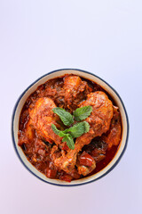 Spicy red chicken curry. Goan style chicken vindaloo. Butter chicken Murgh Makhani curry roast hot and spicy gravy dish Dhaba Punjab, India. North Indian non-vegetarian cuisine Garam Masala. tikka