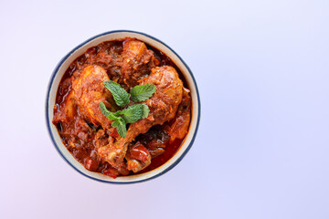 Spicy red chicken curry. Goan style chicken vindaloo. Butter chicken Murgh Makhani curry roast hot and spicy gravy dish Dhaba Punjab, India. North Indian non-vegetarian cuisine Garam Masala. tikka