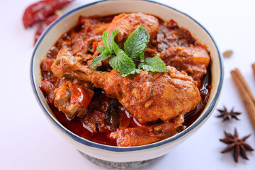 Spicy red chicken curry. Goan style chicken vindaloo. Butter chicken Murgh Makhani curry roast hot and spicy gravy dish Dhaba Punjab, India. North Indian non-vegetarian cuisine Garam Masala. tikka