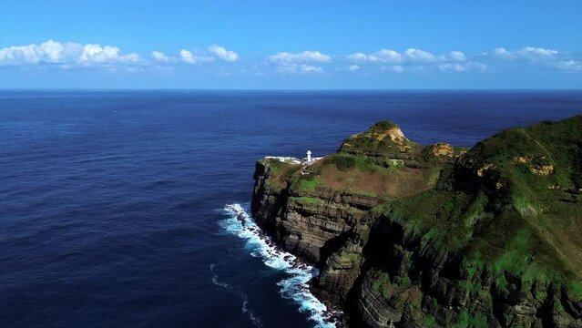 Aerial 4k footage of Bitoujiao lighthouse, a famous scenery of Taiwan northeast corner. Birds eye view in Bitoujiao cape, Ruifang district, New Taipei, Taiwan.