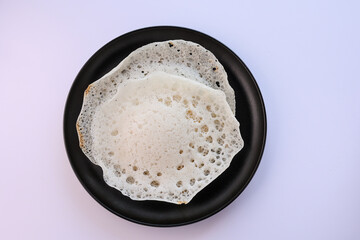 Appam, Kerala breakfast food duck curry or hot and spicy chickpea Masala and milk tea chai,...