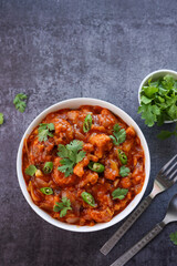 Gobi Manchurian curry gravy, Gobi 65, chilly gobi or cauliflower fry. Popular street food of India made of cauliflower florets Mumbai India.