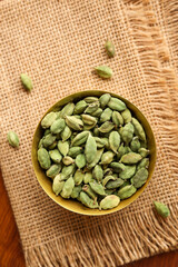 Indian spices for Indian cooking Masala for hot and spicy curry , whole spices turmeric, cardamom, black pepper in wooden spoon, star anise , paprika in Indian spice box Kerala India Sri Lanka.