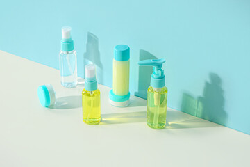 Set of different travel cosmetic products on color background