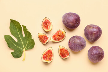 Fresh ripe figs and leaf on orange background