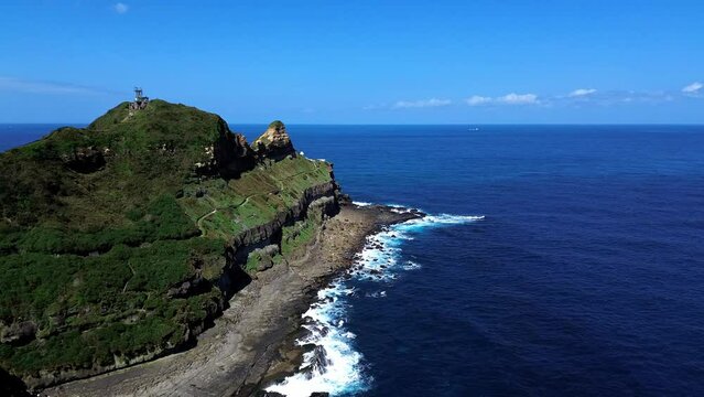 Aerial 4k footage of Bitoujiao lighthouse, a famous scenery of Taiwan northeast corner. Birds eye view in Bitoujiao cape, Ruifang district, New Taipei, Taiwan.