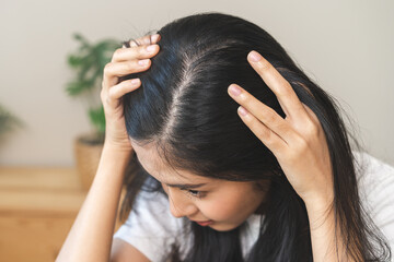 Damaged hair symptom, problem hair fall asian young woman, girl worry about balding, looking at scalp in mirror, hand in break into front hair loss, thin problem. Health care treatment for beauty. - obrazy, fototapety, plakaty