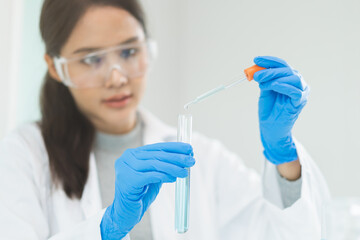 Medical development research laboratory, chemist or science woman scientist student in glass, glove...