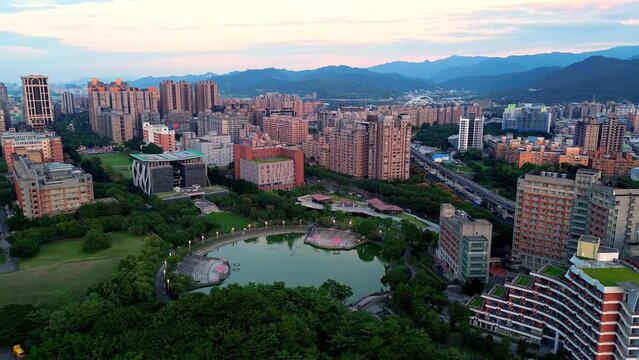 Aerial 4K footage of National Taipei University during sunset. A prestigious university specialized in business and law located in Sanxia District, New Taipei City, Taiwan.