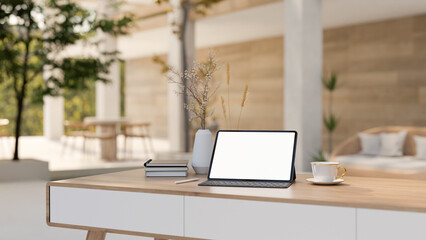 A white-screen digital tablet mockup and accessories on a table in a modern hotel lounge.